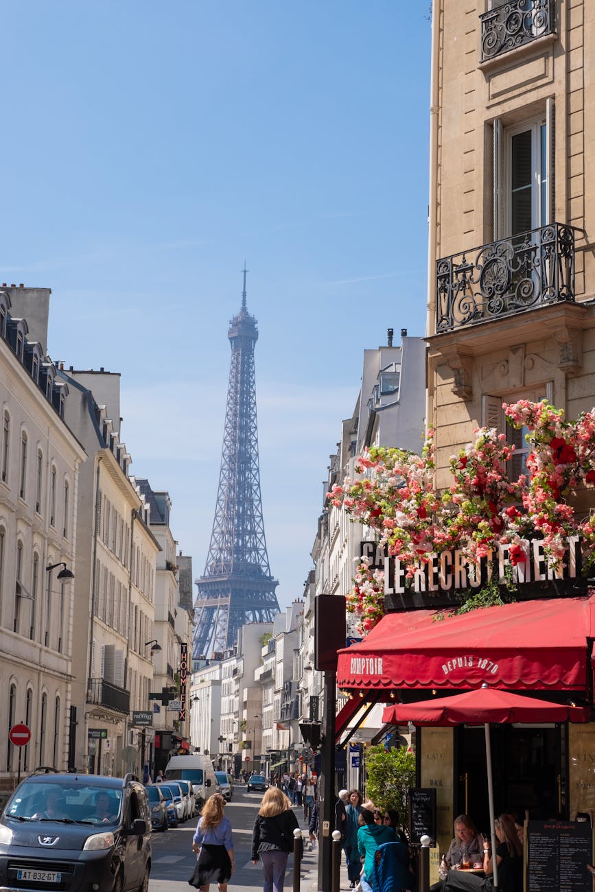 a cafe and the street with the eiffel tower in the background paris france